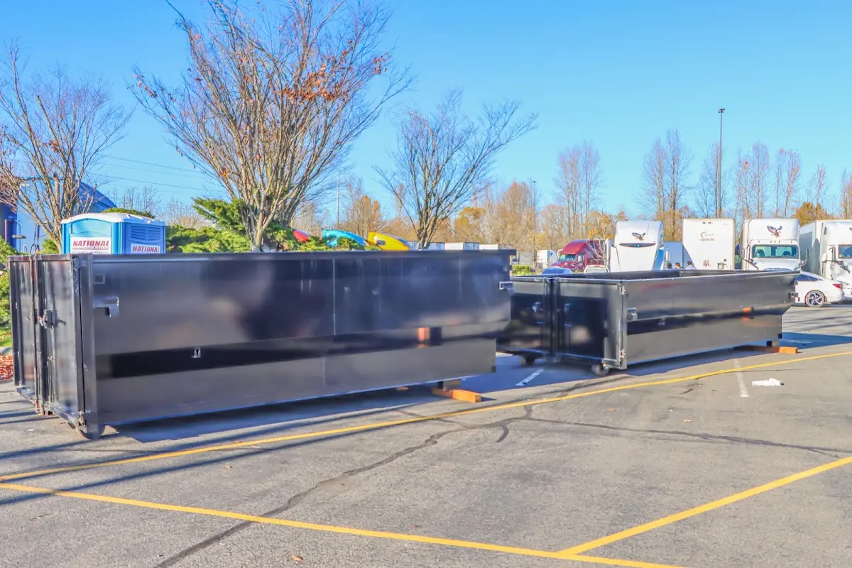Professional dumpster rental service with roll-off container on residential driveway in Silver City